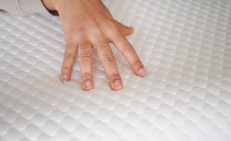 women hand on Orthopedic pillow on a bed