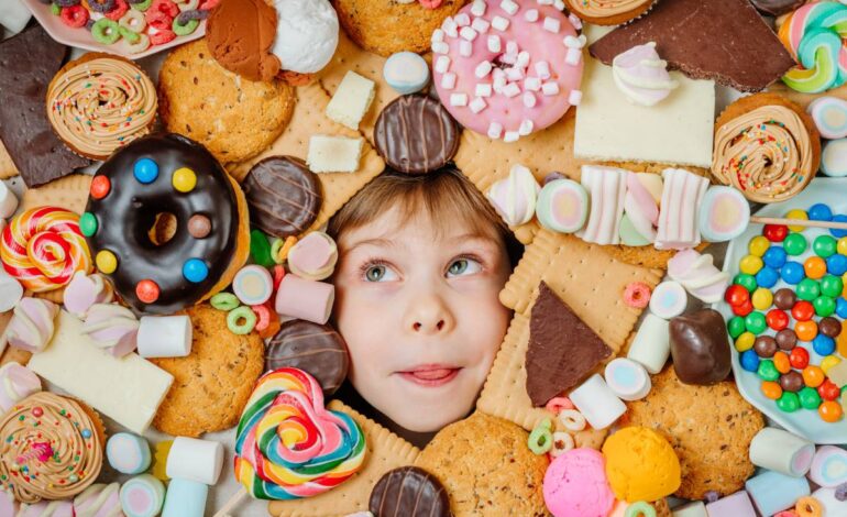 Little girl lying under plenty of sweet foods